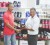 Athlete Elton Bollersm left receives a bottle of the supplements from an employee of Fitness Express.