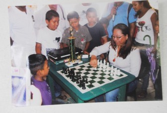 Minister of Amerindian Affairs Pauline Sukhumi and young chess player Daniel Alexander.