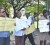 UG staffers holding up placards