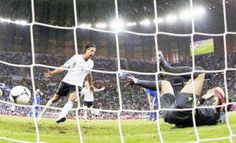 Germany’s Sami Khedira (L) celebrates after scoring a goal past Greece’s goalkeeper Michalis Sifakis during their Euro 2012 quarter-final soccer match at the PGE Arena in Gdansk yesterday. (Reuters photo)