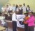 Home Economics teachers of Mackenzie High School (right) accept an iron as part of the donation while members of the Church of Jesus Christ of Latter-day Saints, teachers and students of the school look on.