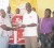 Matthew Langevine (sixth, left), Branch Manager of Scotiabank, Carmichael Street, hands over the donation to a representative of the home, while staff of the bank look on. 