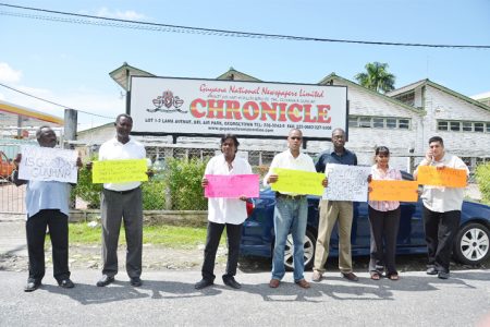 Activists Freddie Kissoon and Mark Benschop (third and fourth from right, respectively) among others protesting outside the Guyana Chronicle’s offices yesterday. 