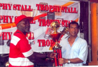O’Neil Durant, left, organizer of the second Inter-market/Municipality Futsal tournament receives  a donation of trophies from Ramesh Sunich, Managing Director of Trophy Stall, Bourda.