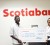 Aspiring designer Andy Cummings beams as he receives his cheque for $500,000 from Scotiabank Marketing Manager Jennifer Cipriani. Scotiabank’s Start Up account is one of the prizes Cummings received for winning Designers’ Portfolio 2012.
