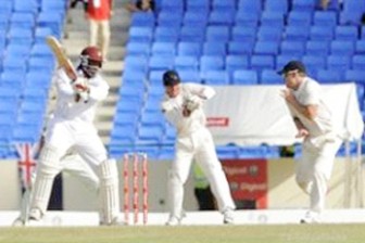  West Indies opener Chris Gayle (left) cuts past wicketkeeper Kruger van Wyk (centre) and close fielder Brendon McCullum during his unbeaten 85. © DigicelCricket.com/Brooks LaTouche 