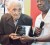 Cecil Cunha receiving an award from General Secretary of the PNCR Oscar Clarke for his longstanding membership with the party during the commencement of the 17th Biennial Congress on Friday.
