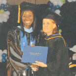 Zola (left) receiving her Bachelor of Arts Degree  in Education from the USM President Annalies Van Den Assem