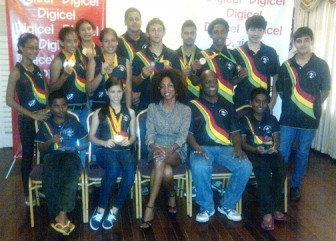 The champion squash team with Coach Carl Ince and Digicel’s Marketing Director Jacqueline James.
