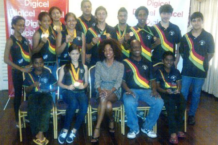 The champion squash team with Coach Carl Ince and Digicel’s Marketing Director Jacqueline James.
