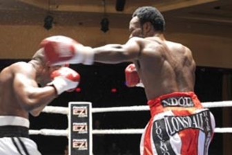 Gairy `Superman’ St Clair, left slips a left jab from Lovemore Ndou during their World Boxing Federation welterweight title fight in Australia on Friday.
