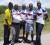 Selso Crawford hands over the sponsorship cheque to coordinator and club coach Randolph Roberts in the presence of Franco Crawford, Leaton Blake and another cyclist.