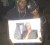 The brother and mother of slain protestor Ron Sommerset display his portrait at the vigil last night
