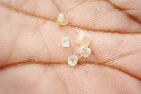 Guyana diamonds just mined in the hand of a diamond miner