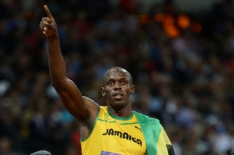 Usain Bolt celebrates after setting a new Olympic record in the 100m final (Jamaica Gleaner photo)