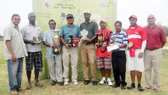 Prize winners of the President’s Cup golf tournament with their trophies. At right is President of the Lusignan Golf Club, Jerome Khan. (Orlando Charles photo)