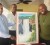 Jackson, right, displays the gift he received from Minister Anthony, left while Permanent Secretary Alfred King, centre looks on.
