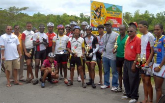  Winners and runners up pose with their trophies and prizes at the conclusion of yesterday’s 50-mile road race which was sponsored by Banks DIH Limited. (Orlando Charles photo)