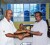 Kishun Bacchus accepts the Crystal Ball from Jerome Khan, President of the Lusignan Golf Club. 