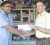 President of the Guyana Chess Federation Shiv Nandalall (right) receives the sponsorship cheque from Ian Doodnauth of Uniparts Auto Spares at the company’s Sheriff Street location on  Monday.