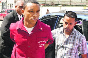 Nicolai Marfan (left) on his way to court yesterday. (Trinidad Express photo)