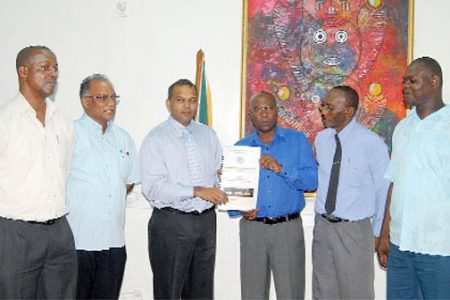 Sport Minister Dr Frank Anthony (third from left) and GABA President Steve Ninvalle  display the GABA’s four-year blueprint document as PS in the Sport Ministry Alfred King and Director of Sport Neil Kumar (first and second from left) and GABA executive members Eustace Cuffy and Terrence Poole look on. (Photo by Orlando Charles) 