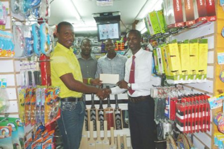 Compton Babb, Marketing Manager of Giftland OfficeMax hands over the cheque to Christopher Barnwell, (left) skipper of the Demerara Cricket Club in the presence of Kashif Amsterdam, left and Marthel Semple.
