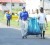 US Ambassador D Brent Hardt and a resident fetch a bag of garbage collected during a community clean-up exercise held in Festival City last weekend. 