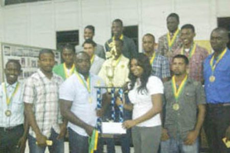 Malteenoes player Orin Forde receives the trophy while the rest of the team looks on.