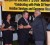 President Donald Ramotar (right) shakes hands with Roraima Airways owner Captain Gerry Gouveia in the presence of his wife Debbie during the 20th anniversary celebration of the airline. (GINA photo)

