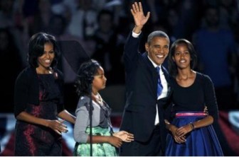 U.S. President Barack Obama, who won a second term in office by defeating Republican presidential nominee Mitt Romney, waves with his daughters Malia (R) and Sasha and wife Michelle (L) before addressing supporters during his election night victory rally in Chicago, November 7, 2012.  REUTERS/Jeff Haynes