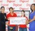 Digicel’s Jacqueline James (right) hands over the cheque to Vidushi Persaud with Ashley deGroot (back left) and Mary Fung-a-Fat looking on.