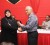 A posthumous award being presented for Bakewell owner Naeem Nasir to his sister Aleema Nasir by Christopher Ram
