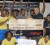 All Smiles! The Leopold Street team and the organizers of the Guinness Greatest of the Streets tournament pose with the $600,000 winner’s cheque and trophy upon completion of Saturday night’s final which was staged at the National Park’s tarmac. (Orlando Charles photo)