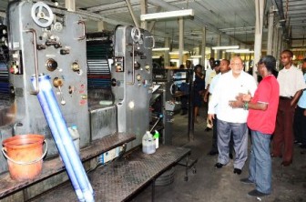 Paul Port explaining details as President Ramotar tours the Guyana National Printers Limited (GINA photo)