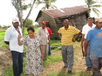 Minister of Local Government and Regional Development Ganga Persaud (third from right) visiting Hyde Park where strong winds damaged the home of Amar Singh, his wife and son. (GINA photo)