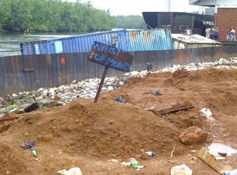 This sign lamenting the waste of money was placed earlier this year by persons near a section of the Kumaka revetment which had begun to sink into the Aruka River. (SN file photo)