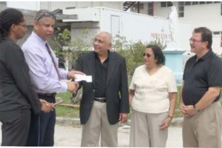 In photo: Browman (left) and Joao (second, left) accept the donation from the Harakhs and Spatafora.