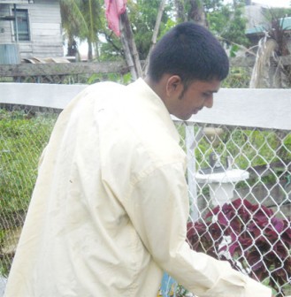 Vishal painting his fence