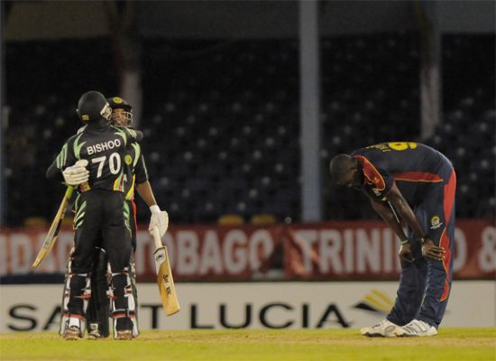 This  picture tells it all, the agony of defeat and the unbridled joy of victory. At left, Guyana’s ninth wicket pair of skipper Veerasammy Permaul and Devendra Bishoo celebrates the stunning last over victory while at right fast bowler Jason Holder is despondent, left to rue what might have been. (Photo courtesy of WICB media)
