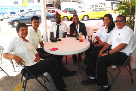 Annette Arjoon-Martins (left) with trainees at ASL’s Flight School and other staffers at the company’s Ogle Complex