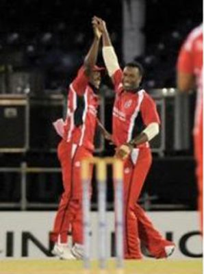 Darren Bravo (left) and Kieron Pollard celebrate as T&T charge to victory. (Photo courtesy WICB) 