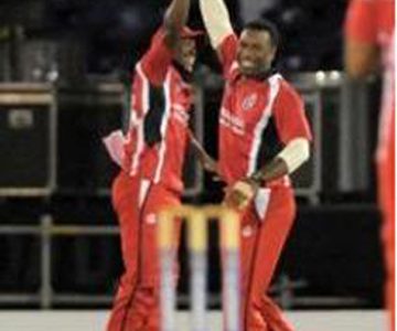 Darren Bravo (left) and Kieron Pollard celebrate as T&T charge to victory. (Photo courtesy WICB) 