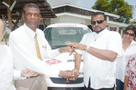 General Secretary of the Universal Peace Federation, Rev. Ronald Mc Garrell  (left) receives the keys to the bus from Roshan Khan (CEO/Founder) of RK’s Group Guyana
