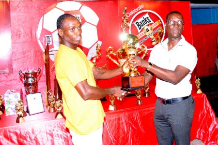 Devon Forde receives his Most Valuable Player award from GFA vice president Mark Phillips. (Aubrey Crawford photo)
