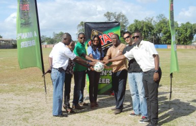 Representative of Ansa McAl Trading Limited and handlers of the MSC ground, pose for a photo opportunity after the simple handing over ceremony of the newly resurface playing field. (Orlando Charles photo)