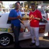 Aubrey Major Jr. on behalf of the Kashif and Shanghai Organization, formally presents the champions’ trophy and the keys to the motor vehicle to Buxton United’s captain, Dwain Jacobs.
