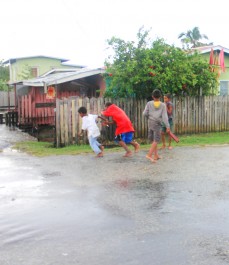 Zeelugt youths enjoying a spirited game of catch ya in the rain