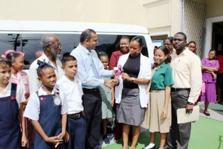 Minister of Culture, Youth and Sport, Dr. Frank Anthony presents keys to the vehicle to the Assistant Secretary, (Admin) of the Culture, Youth and Sport Ministry, Alexis Sullivan. (GINA photo)
