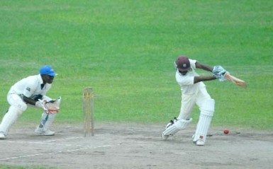 Rajendra Chandrika drives through the off-side on his way to an unbeaten 52 in Demerara’s first innings score of 107-1 against the President’s XI yesterday. (Orlando Charles photo)